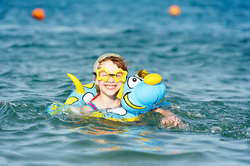 Image showing little girl swimming in sea