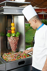 Image showing Arab chef making kebab