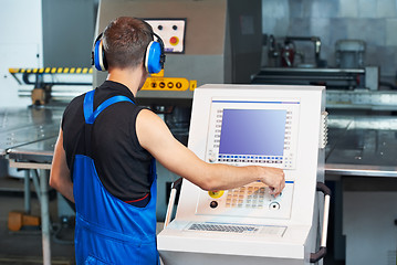 Image showing worker operating cnc punch press