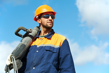 Image showing portrait of construction worker with perforator