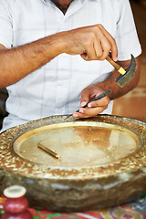 Image showing calker handwork of brass plate