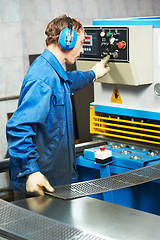 Image showing worker operating guillotine shears machine