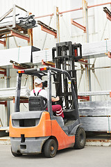 Image showing worker driver at warehouse forklift loader works