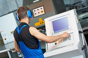 Image showing worker operating cnc punch press