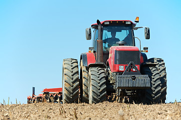 Image showing Ploughing tractor at field cultivation work