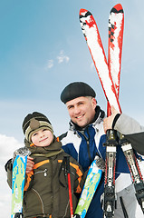 Image showing Smiling son and father with skis at winter