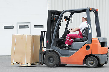 Image showing warehouse worker driver in forklift