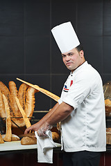 Image showing Arab chef cutting bread