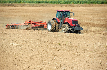 Image showing Ploughing tractor at field cultivation work