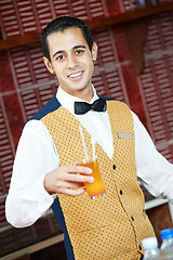 Image showing Cheerful arab barman