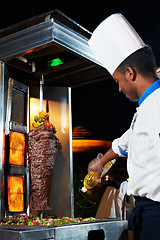 Image showing Arab chef making kebab