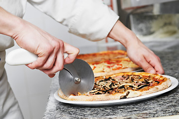 Image showing Pizza preparartion - cutting