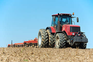 Image showing Ploughing tractor at field cultivation work