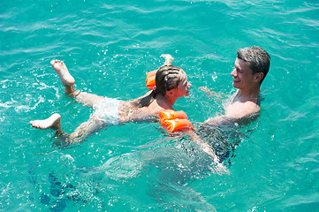 Image showing active couple at sea beach with snorkel  set