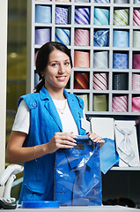 Image showing Young salesperson girl at clothes shop