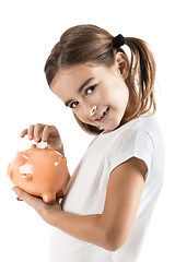 Image showing Little girl with a piggy-bank