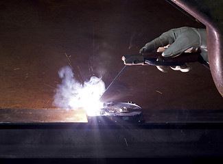 Image showing welding on open hard disk drive in rusty background