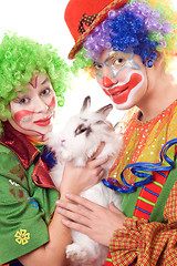 Image showing Two smiling clown with a white rabbit
