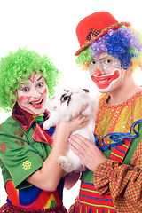 Image showing Two joyful clown with a white rabbit