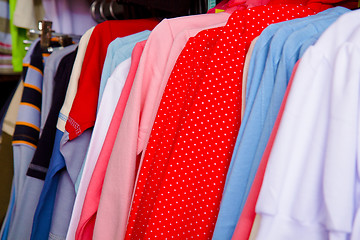 Image showing Bright children's clothes on a hanger in the store