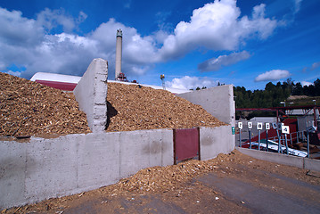 Image showing bio power plant with storage of wooden fuel against blue sky