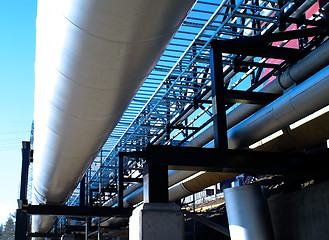 Image showing Industrial zone, Steel pipelines and valves against blue sky