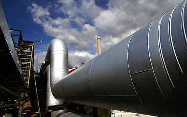 Image showing Industrial zone, Steel pipelines and valves against blue sky