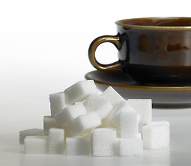 Image showing lump sugar and brown coffee cup