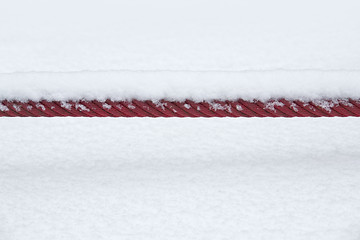 Image showing snowcapped red rope
