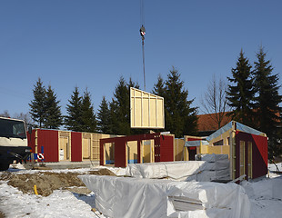 Image showing wooden house construction in sunny ambiance