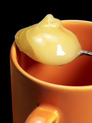 Image showing cup and honey spoon