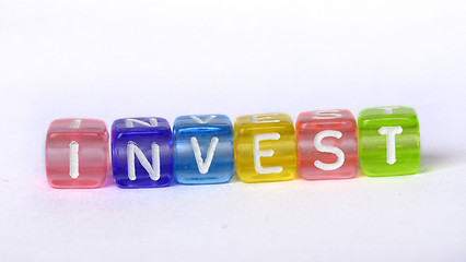 Image showing Text Invest on colorful wooden cubes 