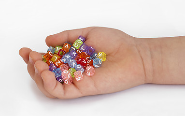 Image showing Children hand holding cubes with letters