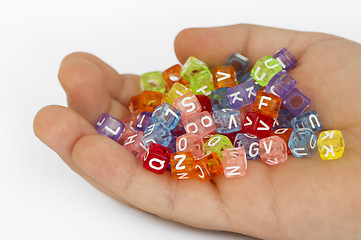 Image showing Children hand holding cubes with letters