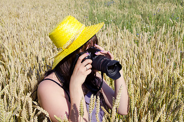 Image showing Woman taking shots in field of wheat.