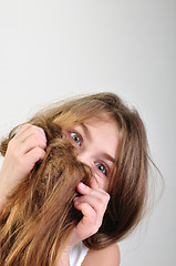 Image showing girl hiding behind her hair