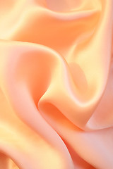 Image showing Smooth elegant golden pink silk as background