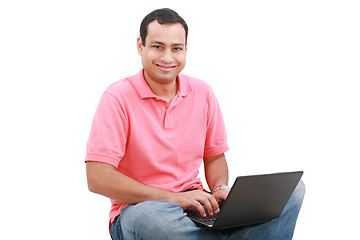 Image showing Man sitting on the floor with a laptop - isolated over a white b