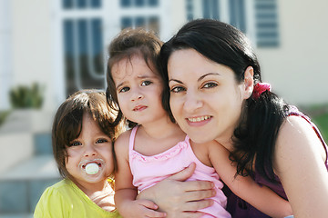 Image showing Mother and Daughters portrait outdoors in front of their home