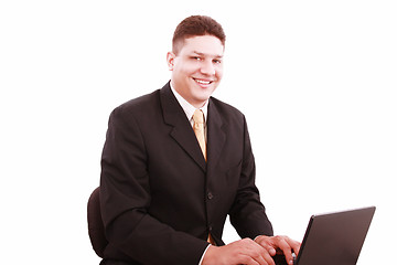 Image showing Portrait of businessman in front of laptop computer 