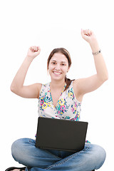 Image showing woman with laptop sitting on the floor and celebrating her succe