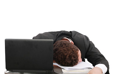 Image showing young business man sleeping on the laptop 