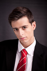 Image showing Portrait of a young business man isolated on black background