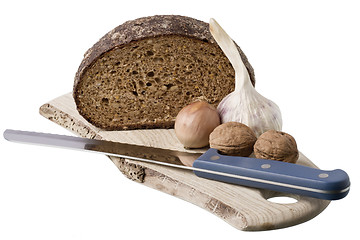 Image showing brown bread on shelf with onion, garlic and walnut