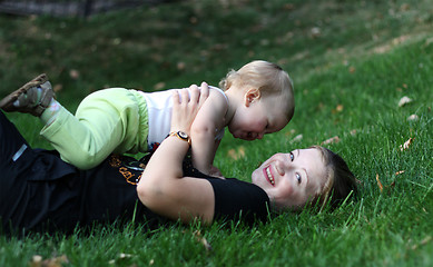 Image showing Mother with sone play on a grass