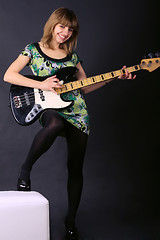 Image showing Young beautiful girl with a guitar