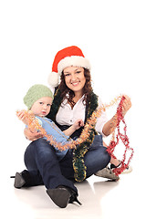 Image showing Girl in a santa hat with a little  boy