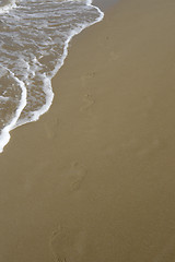 Image showing waterside footprints in the sand