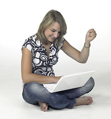 Image showing successful computing girl sitting in light back