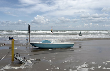 Image showing green boat at ebb tide